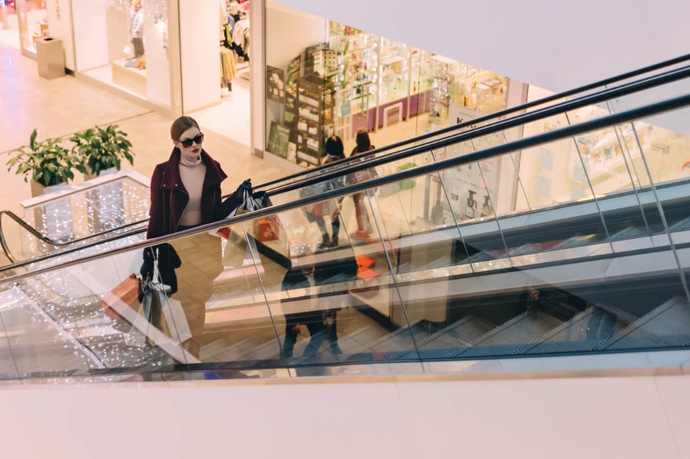 women-shopping-on-escalator